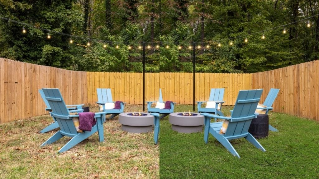 Six blue Adirondack chairs with purple towels are arranged around two round fire pits on green grass, surrounded by a wooden fence and string lights, with trees in the background.
